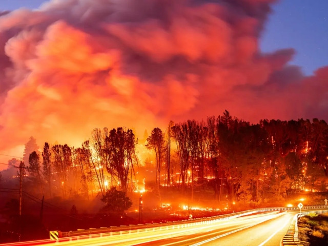 seen in a long exposure photograph the park fire burns along highway 32 in the forest ranch community of butte county calif on thursday july 25 2024 ap photo east bay times